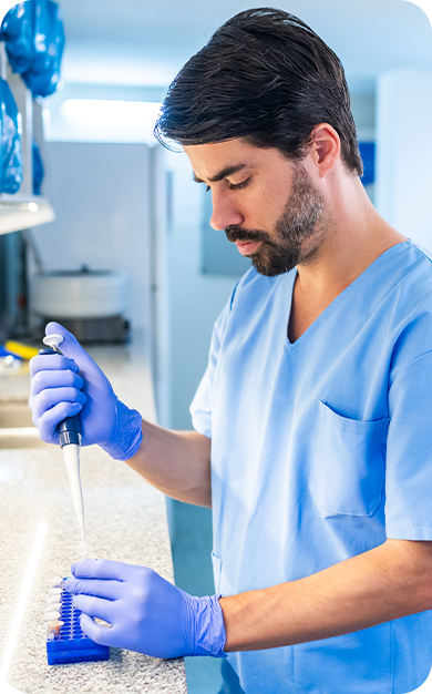 Scientist using a pipette in a lab.